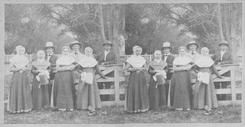 SA0158 - A group of Shakers, most likely from the Church Family at Watervliet, NY, are shown along a wooden fence. Identified on both the front and back.